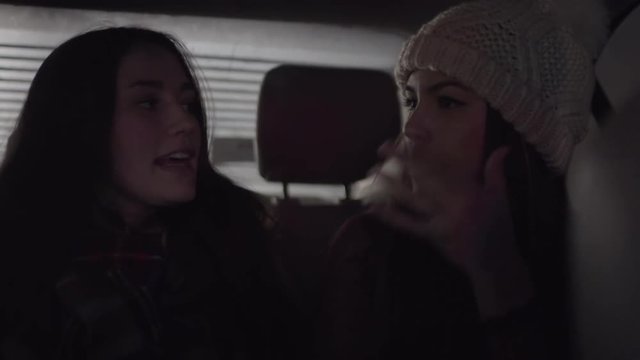 Carefree Young Women Sing And Dance In The Backseat Of Moving Car At Night