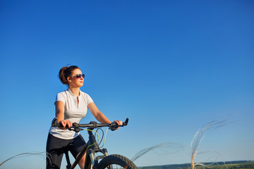 Portrait of healthy fit and sporty, confident and successful mature woman cycling on mountain bike