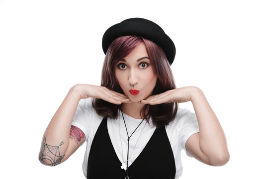 young surprised tattooed girl with purple hair, isolated on white