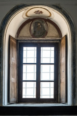 Fototapeta premium Church Window with a Wooden Frame and Shutters