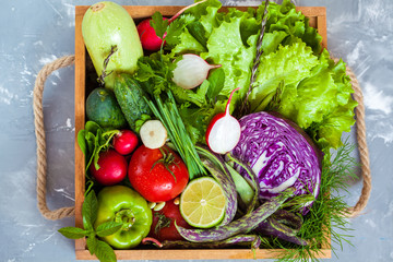 Summer vegetables in a wooden box. Love for a healthy vegan food concept.