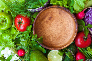 Summer vegetables - ingredients for salad and a wooden empty bowl. Love for a healthy vegan food concept.