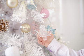 Fototapeta na wymiar new year tree and decoration and boys hand