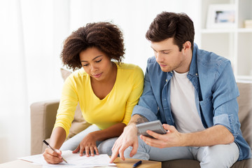 couple with papers and calculator at home