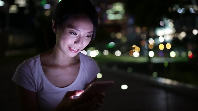 Woman reading on mobile phone
