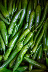 A lot of hot spicy chili green red peppers background