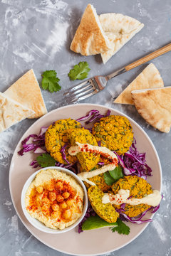 Baked falafel with hummus, vegetables and pita. Love for a healthy vegan food concept.