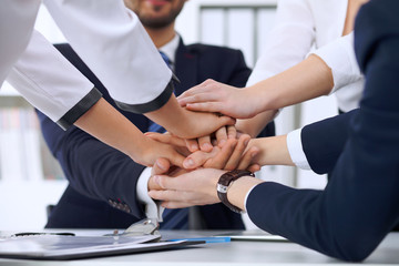 Business people group Business people group happy showing teamwork and joining hands or giving five...