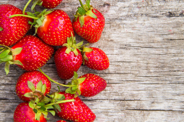 Ripe fresh strawberries on rustic wooden background with copy space. Top view