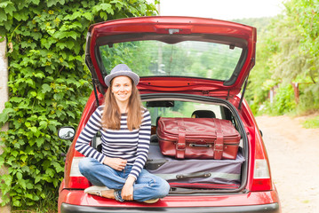 Girl happy travel suitcases car summer landscape