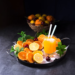 Fototapeta na wymiar Orange lemonade with lemon and mint