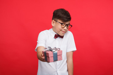 Shy boy offering giftbox