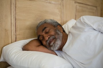 Senior man sleeping on bed in the bedroom - Powered by Adobe