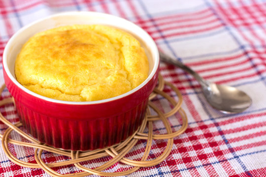 cheese souffle on a red and white cloth in a red bowl