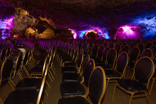 Colored chairs in the cave before the concert.