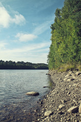 Summer lake landscape with beautiful water, lots of green vegetation and sunlight. - 163012508