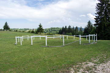 Fototapeta na wymiar A wooden fence for horses on a farm of horses
