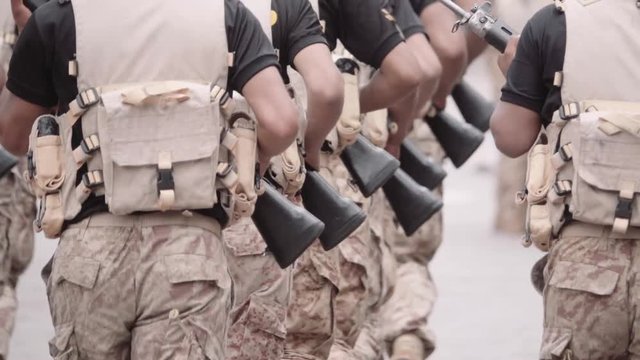 Soldiers running and holding rifle during a practice at the military installations. Slow motion