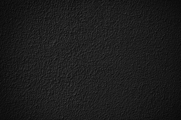 Black grainy plaster wall texture.