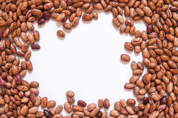 Dry brown beans on white background.