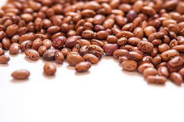 Dry brown beans on white background.