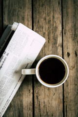 top view of cup of coffee and newspaper