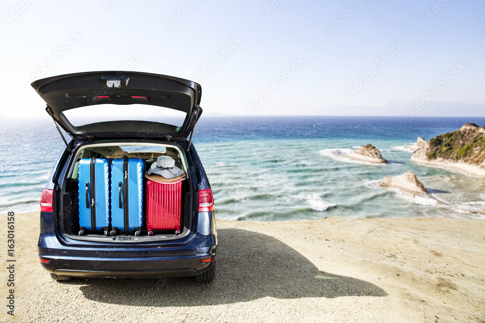 Wall mural summer time and car on beach with landscapeo of cliffs 