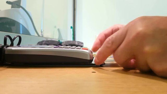 Man inserts a PIN code into the card reader.