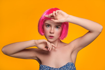 Young model posing in pink wig