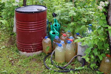 Barrels, canisters and watering cans with water