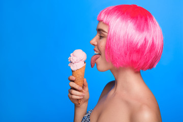 Side view of woman licking ice cream - obrazy, fototapety, plakaty