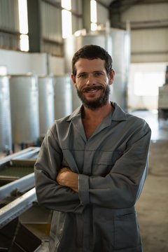 Portrait of worker standing with arms crossed