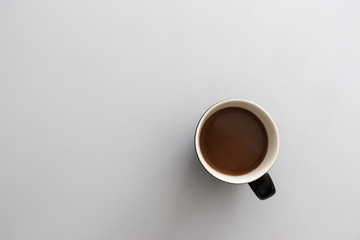coffee cup on white table. top view