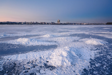 Beautiful winter landscape with frozen river at Dusk