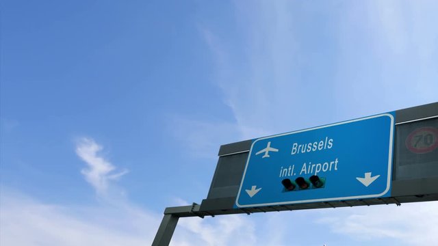 airplane flying above brussels airport signboard