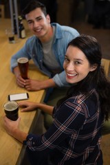 Portrait of happy young friends enjoying drinks