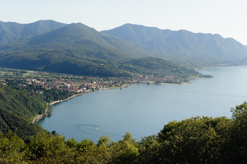 Fototapeta na wymiar View from above on Luino and Lago Maggiore with the mountain peaks in the background