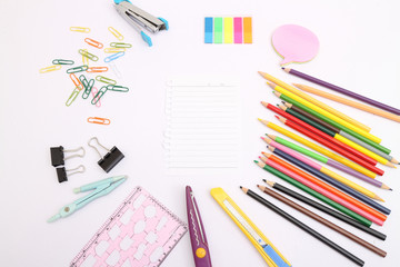 Naklejka premium Front view and close up of messy office table with laptop display, cellphone, coffee cup, decorative plants, colorful supplies and other items. Mock up
