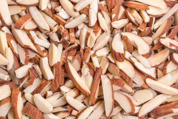 Detail of roasted almond sticks pile, natural source of good fat and protein.