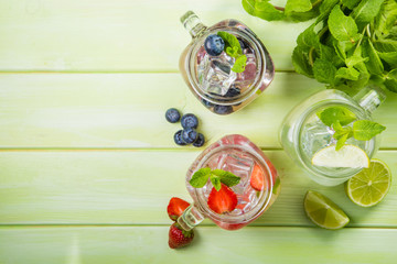 Selection of colorful mojitoes in glasses