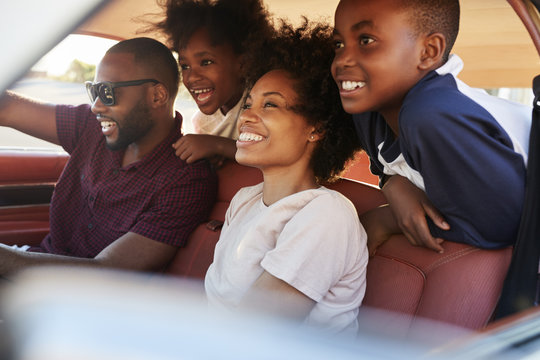 Family Relaxing In Car During Road Trip