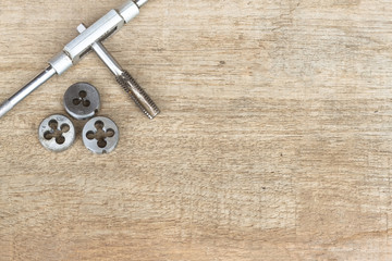 Tool for threading on the wood background.