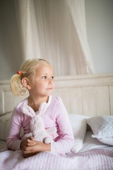 Girl relaxing on bed in the bedroom at home