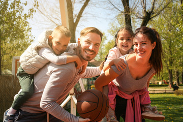 Happy family outdoor with basketballs.