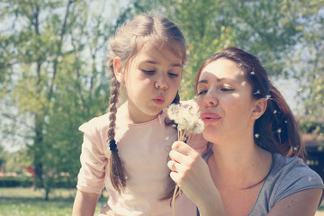 Mother and daughter in the meadow.
