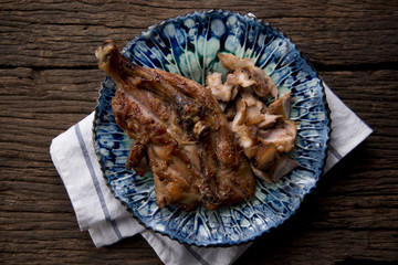 Thai food. Grill chicken wings with spicy sauce on wooden table.