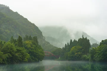 Zelfklevend Fotobehang Japanese nature landscape of mountains, river and bridge in fog © Olga K
