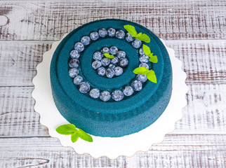 Chocolate velour cake with blueberries and basil leaves