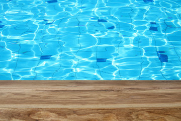 top view of swimming pool and wooden table background