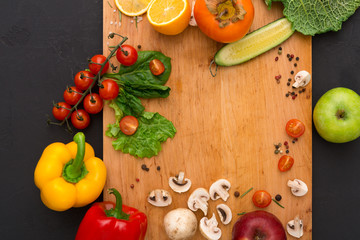 Frame of fresh vegetables on wooden background with copy space